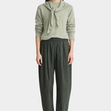 Apiece Apart Spa Pleat Pant Rosin side view showcasing the sculptural barrel leg shape, front pleats, and side pocket detail.