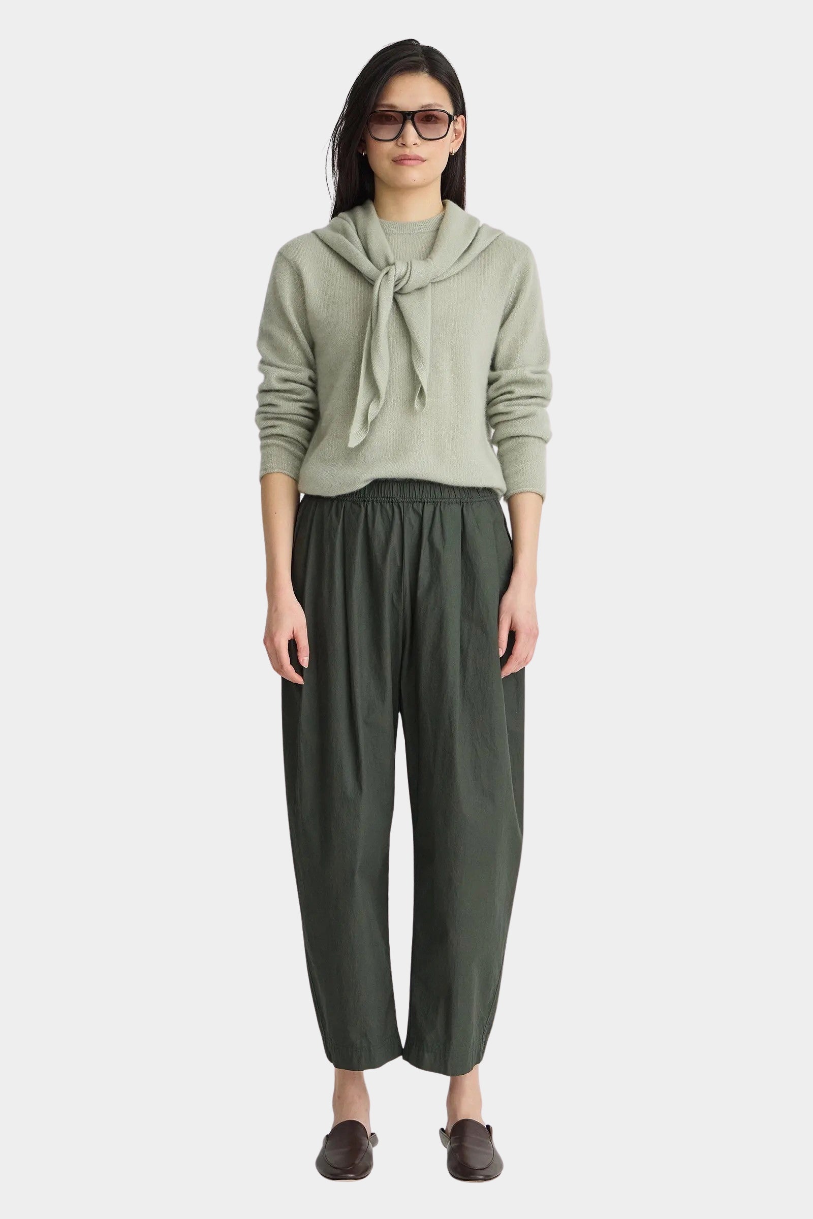Apiece Apart Spa Pleat Pant Rosin side view showcasing the sculptural barrel leg shape, front pleats, and side pocket detail.