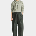 Apiece Apart Spa Pleat Pant Rosin on model featuring a relaxed barrel leg silhouette, elastic waistband, front pleats, side pockets, and cropped ankle length. YUCCA Denver
