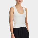 Cream Uri Low-Cut Tank by Apiece Apart styled with black trousers and silver jewelry