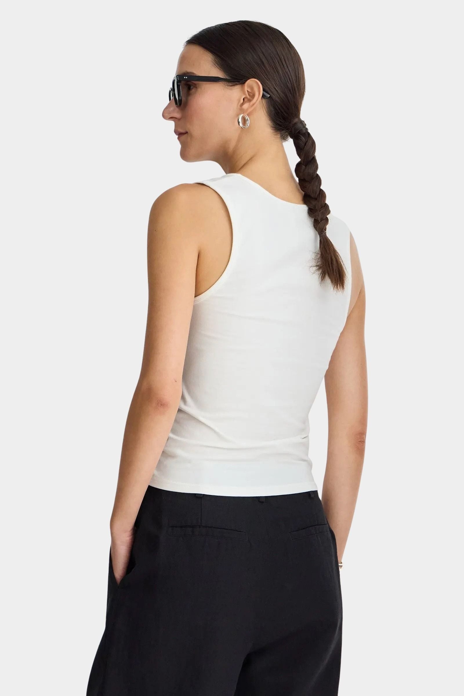 Apiece Apart Uri Low-Cut Tank Cream back view with fitted stretch silhouette and tailored black trousers