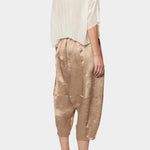 Atelier Delphine Kiko pant in latte angled back view showing textured fabric and elastic waistband