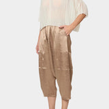 Atelier Delphine Kiko pant in latte worn with sheer top showing cropped wide leg fit and elastic waist
