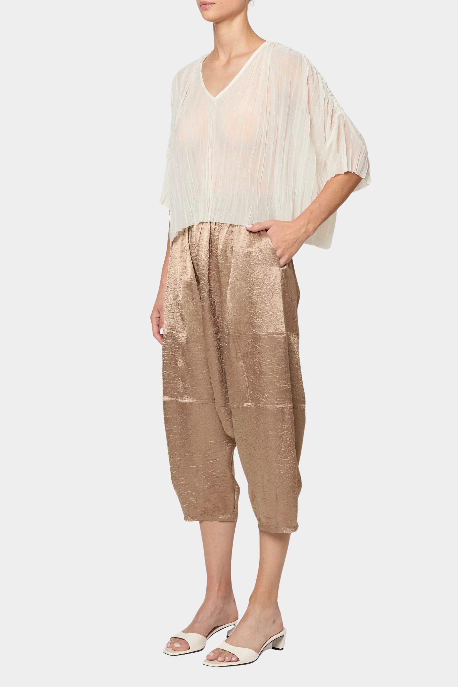 Atelier Delphine Kiko pant in latte worn with sheer top showing cropped wide leg fit and elastic waist