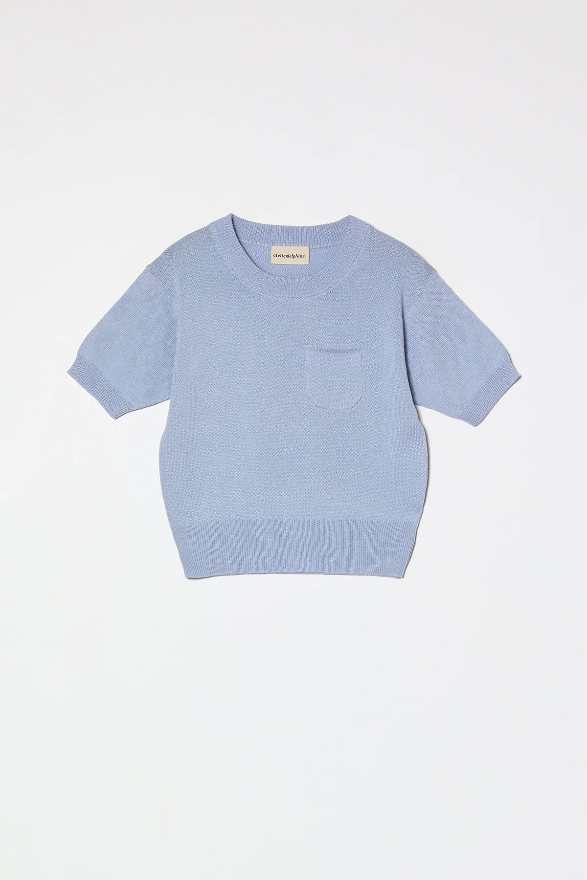 Atelier Delphine Mari Mari knit top pastel blue product flat lay with short sleeves and pocket detail