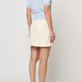 Atelier Delphine Mari knit top in pastel blue front view with short sleeves and chest pocket