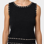 Atelier Delphine knit tank top in black and tan close-up showing textured knit and contrast stitching at neckline