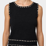 Atelier Delphine knit tank top in black and tan close-up showing textured knit and contrast stitching at neckline
