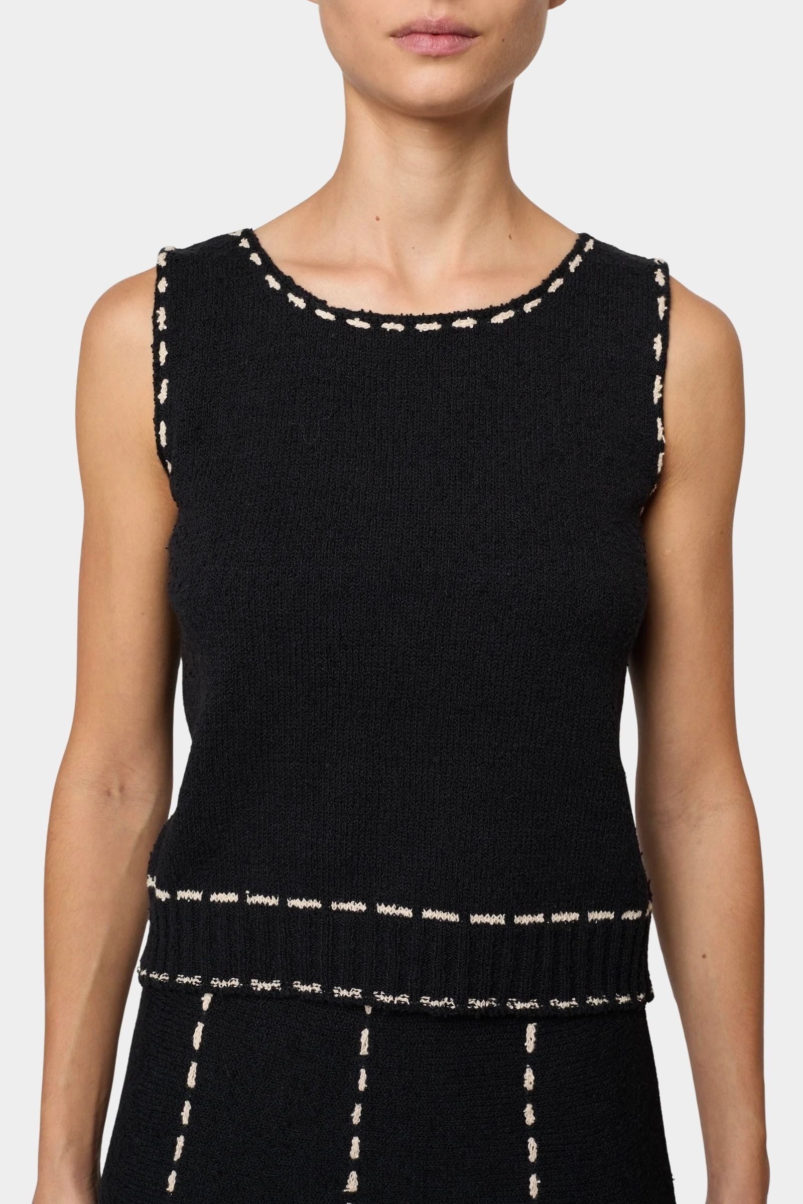 Atelier Delphine knit tank top in black and tan close-up showing textured knit and contrast stitching at neckline