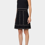 Atelier Delphine knit tank top in black and tan worn with matching knit skirt showing sleeveless cropped fit