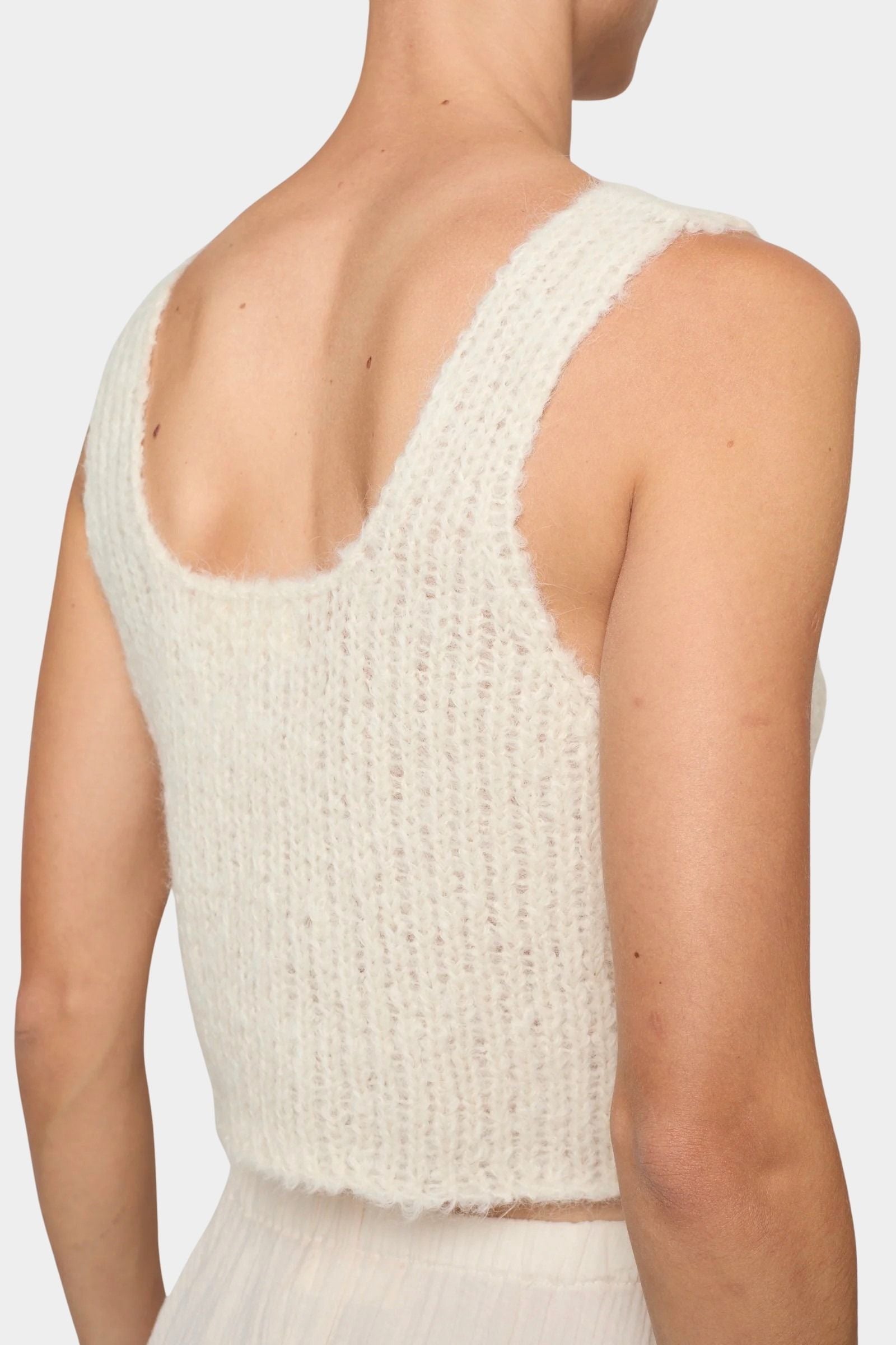 Atelier Delphine super crop sweater tank in cream angled back view showing wide straps and textured knit