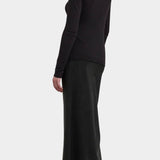 Black Crane Bias Skirt Black back three quarter view showing fluid full length drape