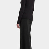 Black Crane Boat Neck Long Sleeve Black back three quarter view styled with a long black skirt