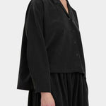 Black Crane Cropped Long Sleeve Black side view showing relaxed cropped silhouette