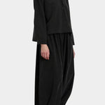 Black Crane Cropped Long Sleeve Black styled with matching pants, three quarter view at YUCCA Denver
