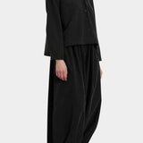 Black Crane Cropped Long Sleeve Black styled with matching pants, three quarter view at YUCCA Denver