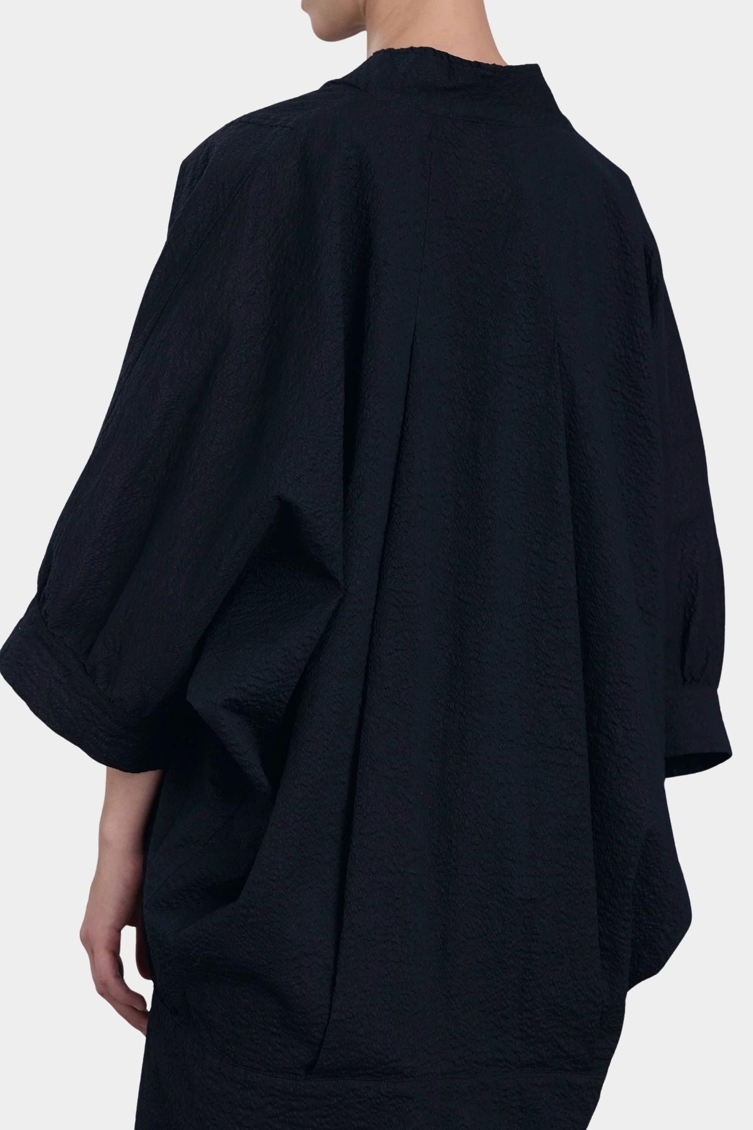 Black Crane spoon jacket midnight angled back view balloon sleeve detail volume