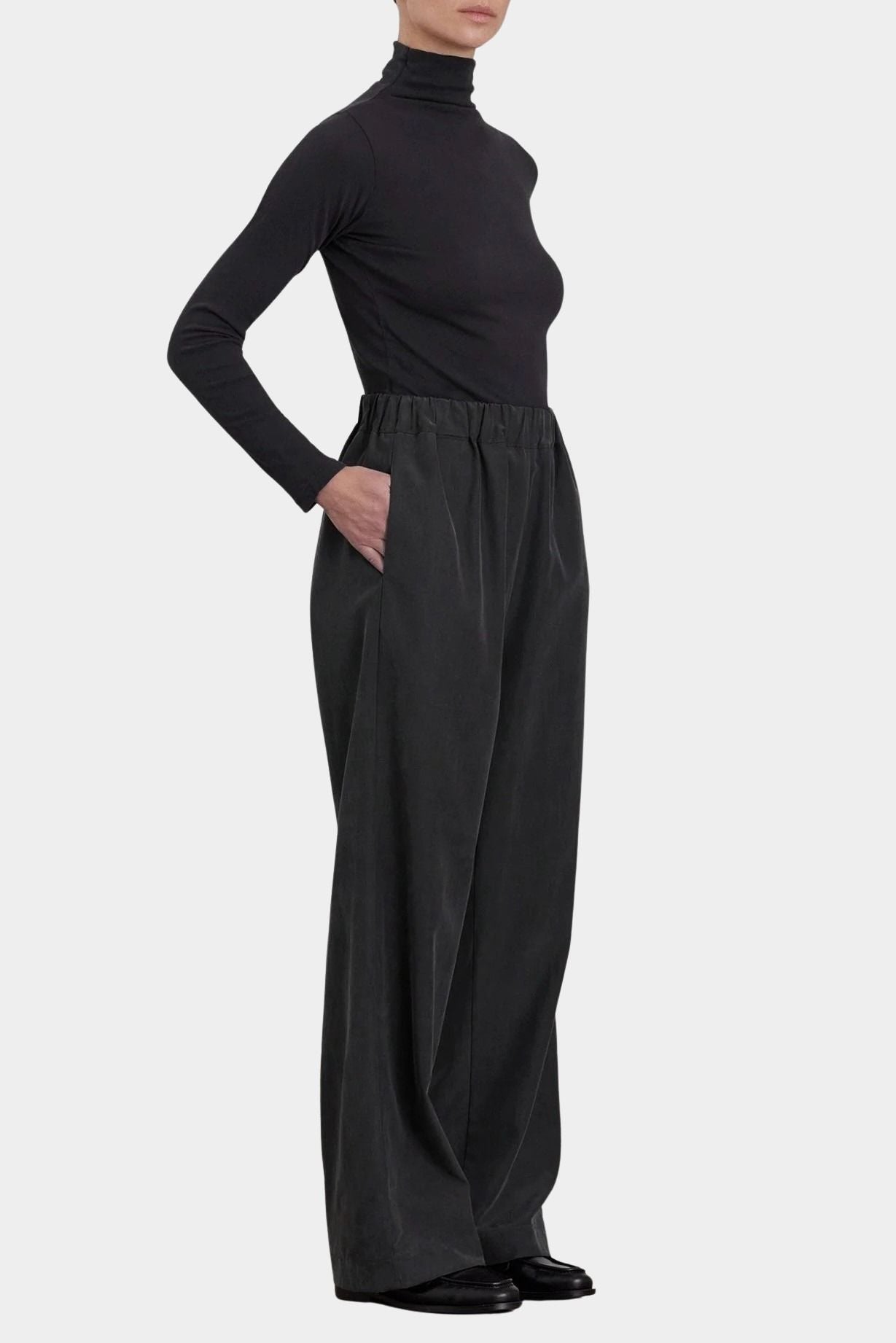 Black Crane Straight Pants Black side view showing relaxed fit, side pocket and draped straight leg