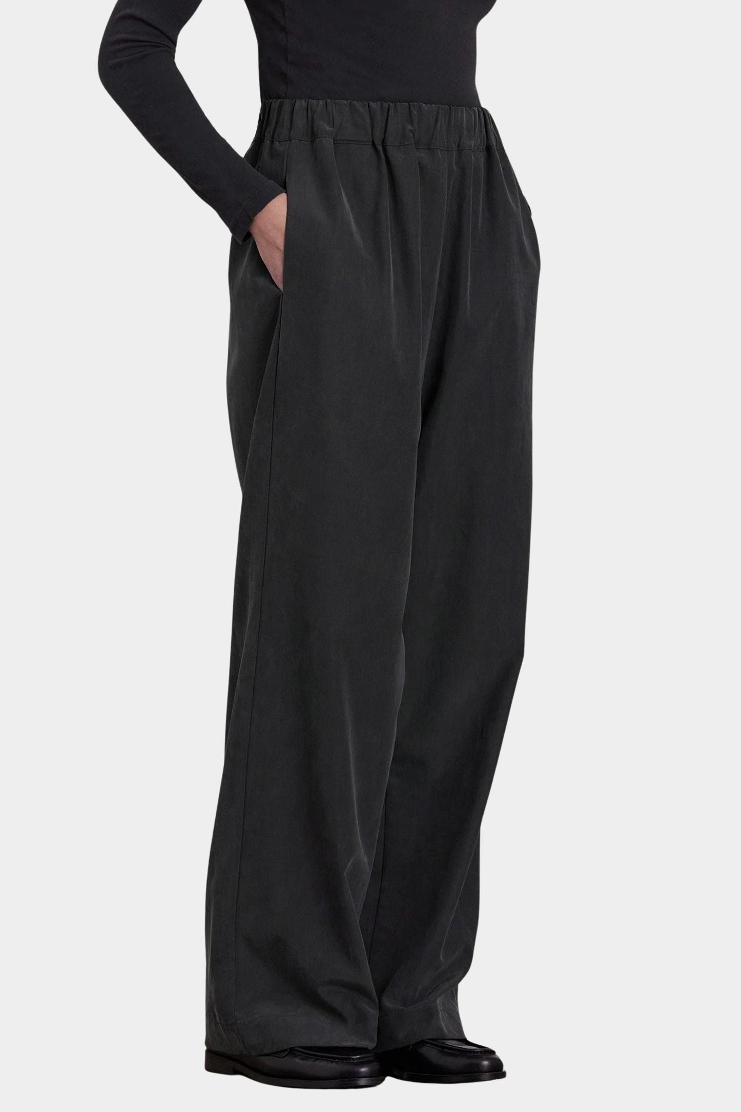 Black Crane Straight Pants Black three quarter view with elastic waist, side pockets and relaxed straight leg