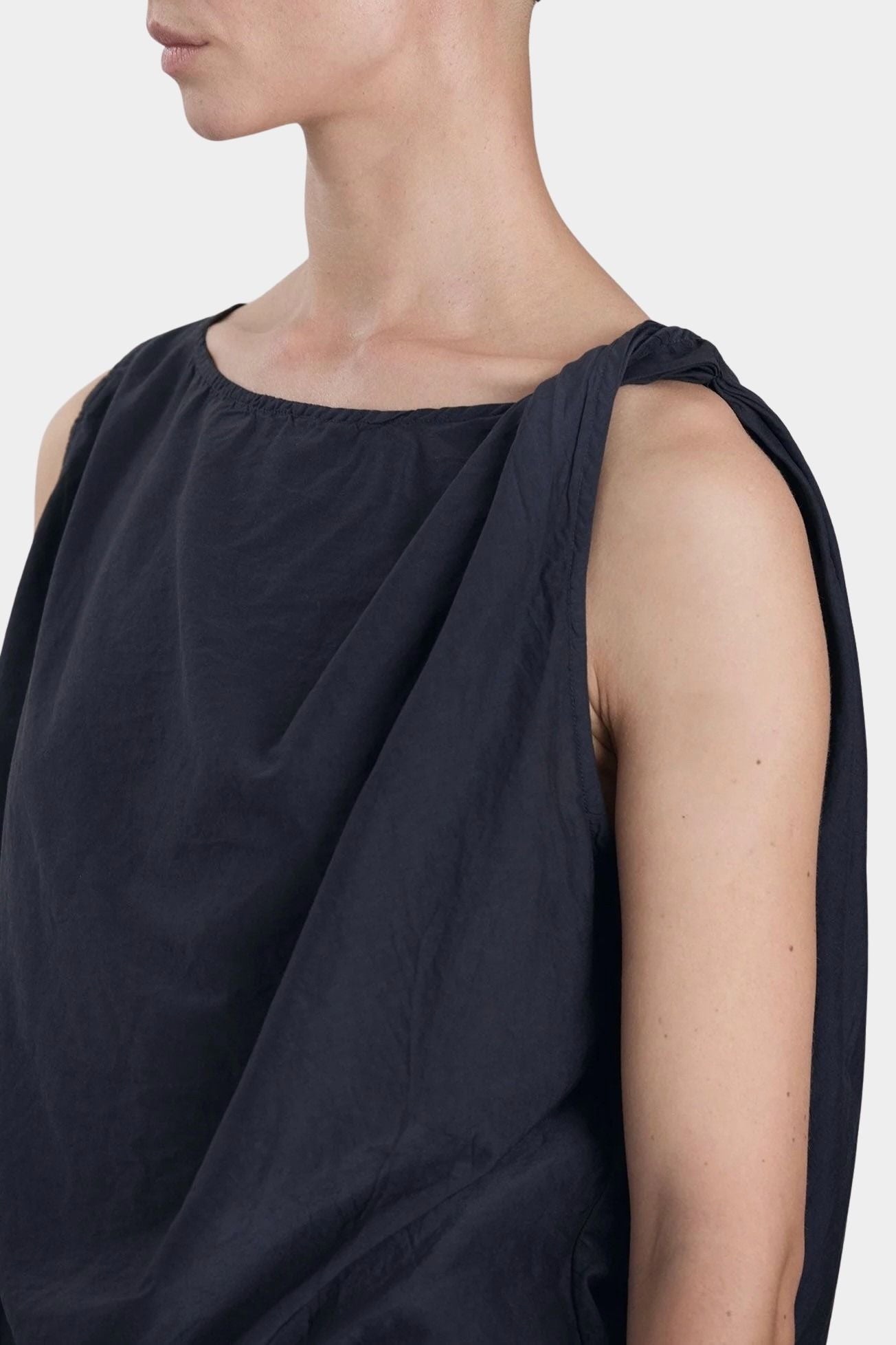 Black Crane twisted tank top faded black side profile showing loose fit and fluid shape