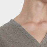 Black Crane v neck dress p grey neckline detail raw edge v neck cotton close up