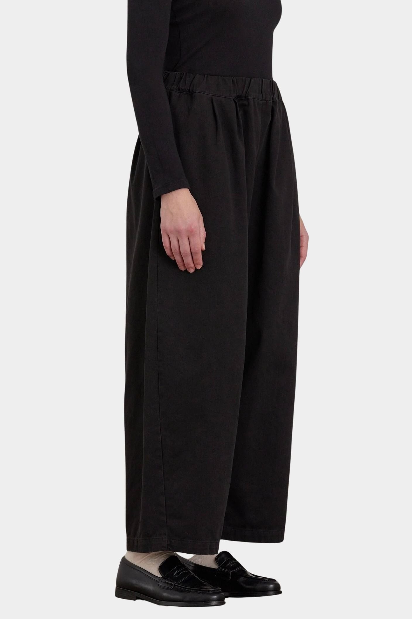 Black Crane Wide Pants Black side view showing relaxed volume and ankle length
