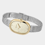 Angled view of BREDA Jane Tethered watch showing gold plated oval case and woven silver stainless steel bracelet