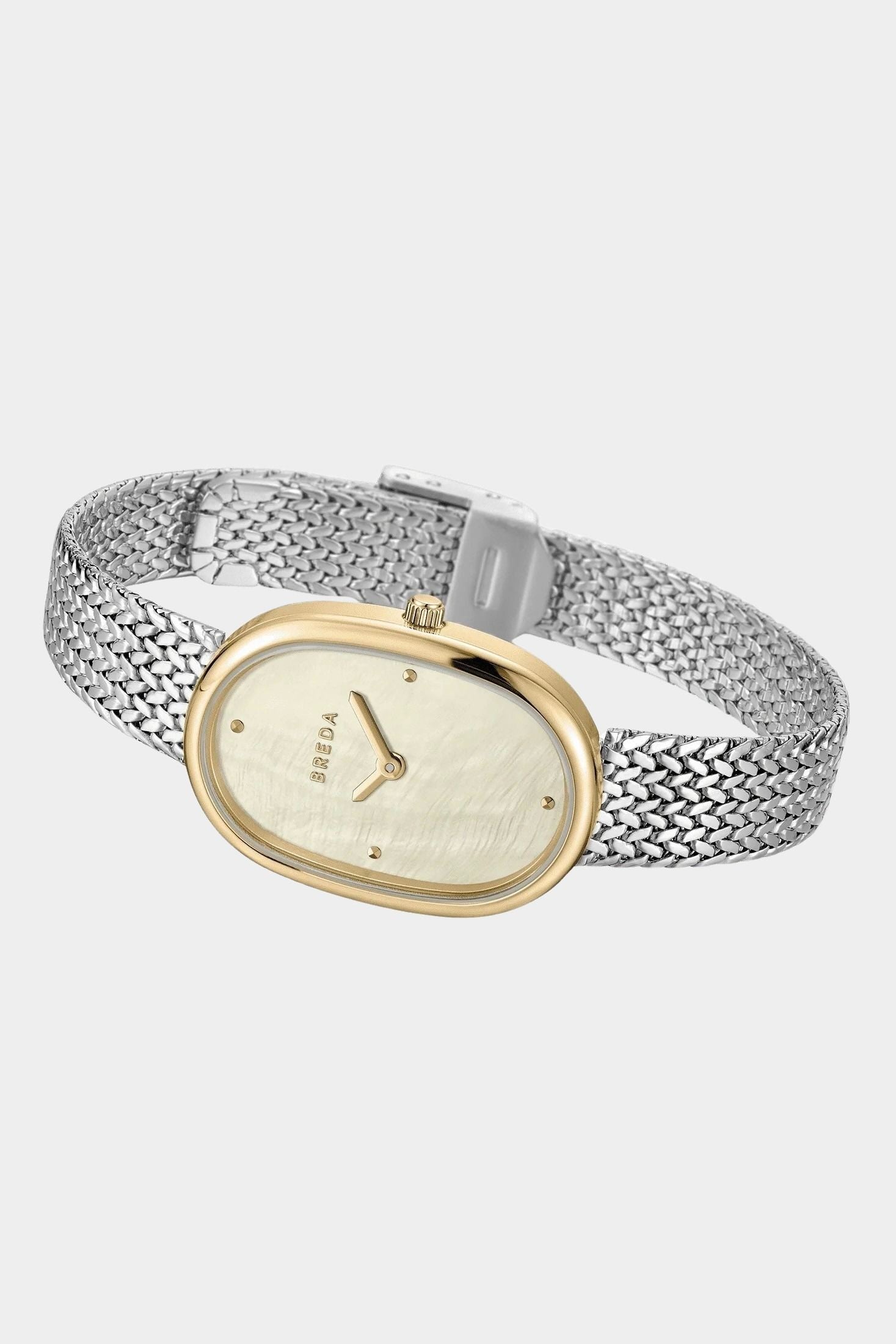 Angled view of BREDA Jane Tethered watch showing gold plated oval case and woven silver stainless steel bracelet