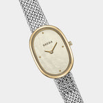 BREDA Jane Tethered watch with gold oval case, mother of pearl dial and woven silver bracelet at YUCCA Denver