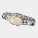 Side view of BREDA Jane Tethered two tone watch with curved gold case and textured silver bracelet