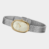 Side view of BREDA Jane Tethered two tone watch with curved gold case and textured silver bracelet