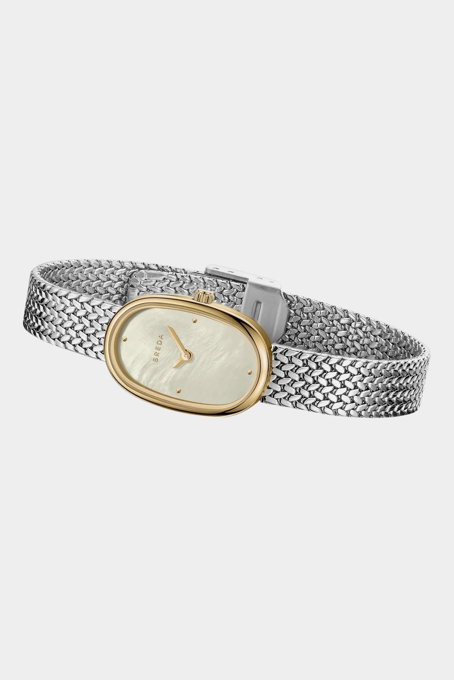 Side view of BREDA Jane Tethered two tone watch with curved gold case and textured silver bracelet