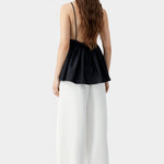 Black camisole top with thin straps, gathered back, and soft drape