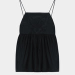 Black cotton camisole top with tonal embroidered motif, thin straps, and gathered waist seam