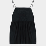 Black cotton camisole top with tonal embroidered motif, thin straps, and gathered waist seam
