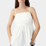 White cotton camisole with embroidered tonal motif at bust, thin straps, and structured upper panel