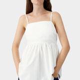 White cotton camisole with embroidered tonal motif at bust, thin straps, and structured upper panel