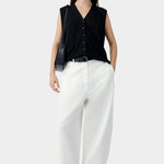 White cotton linen curved pants with relaxed fit and subtle taper, worn with black sleeveless top and sandals