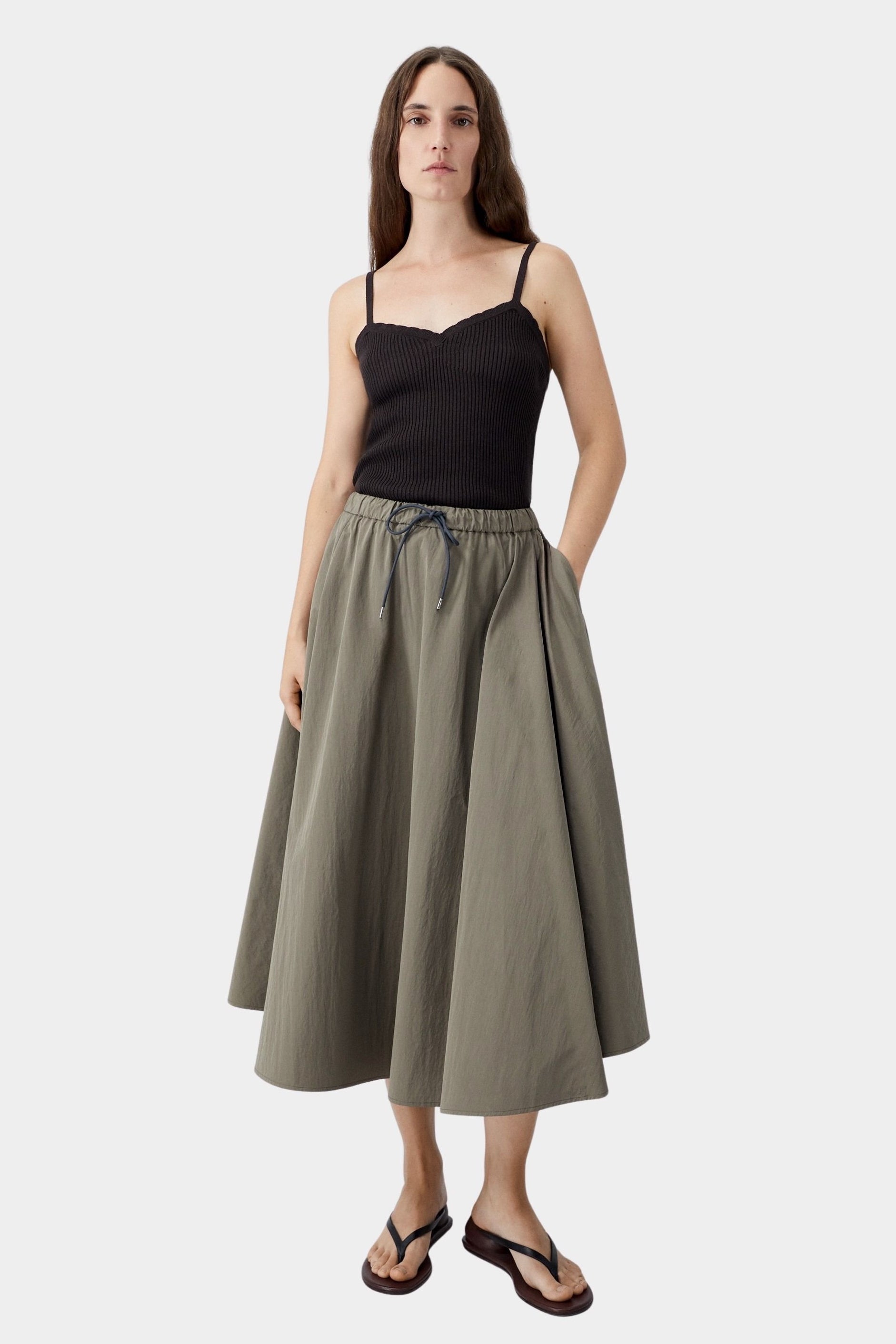 Brown ribbed knit tank top worn with full skirt and sandals