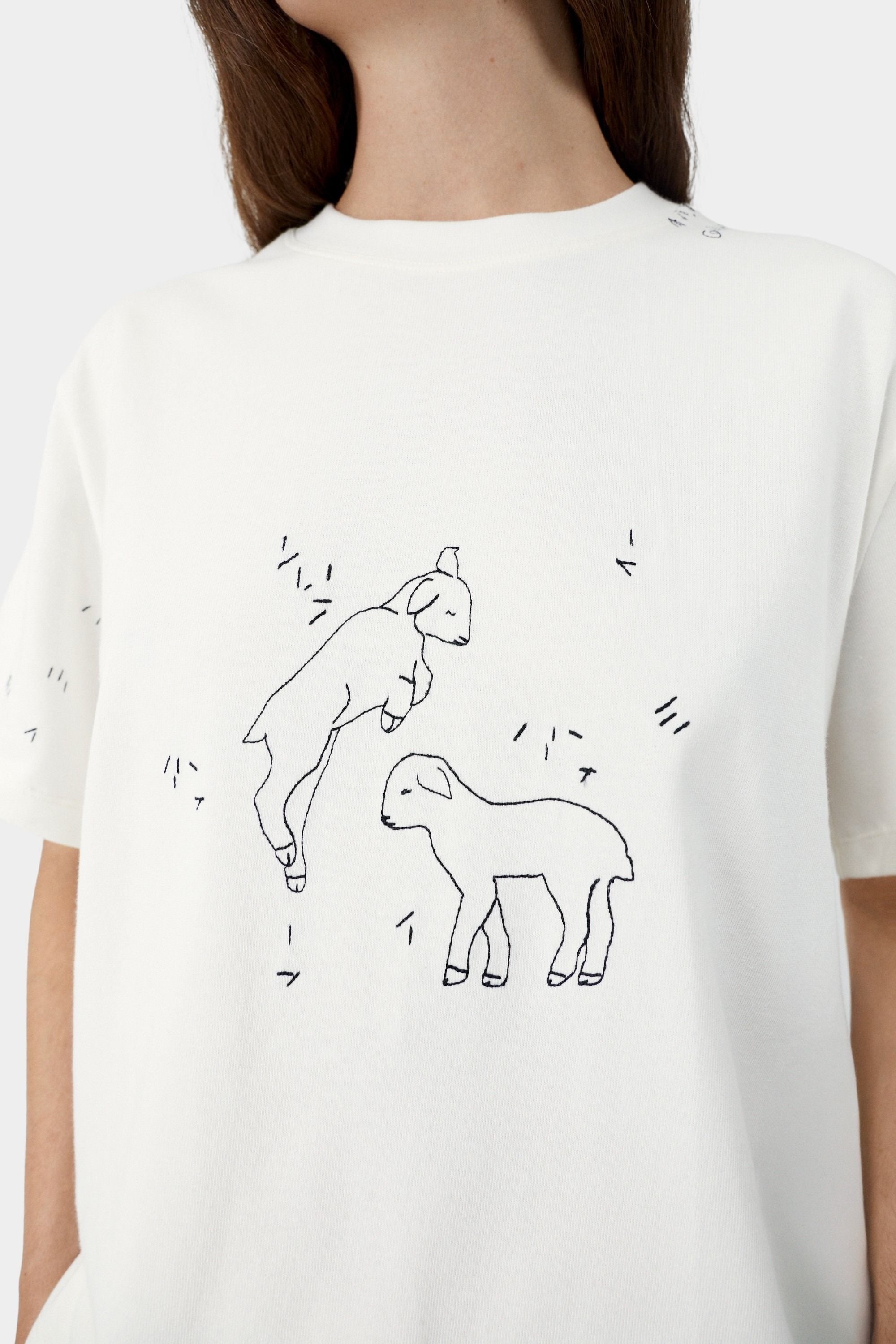 White cotton t-shirt with embroidered lamb illustration and fine line detailing on front