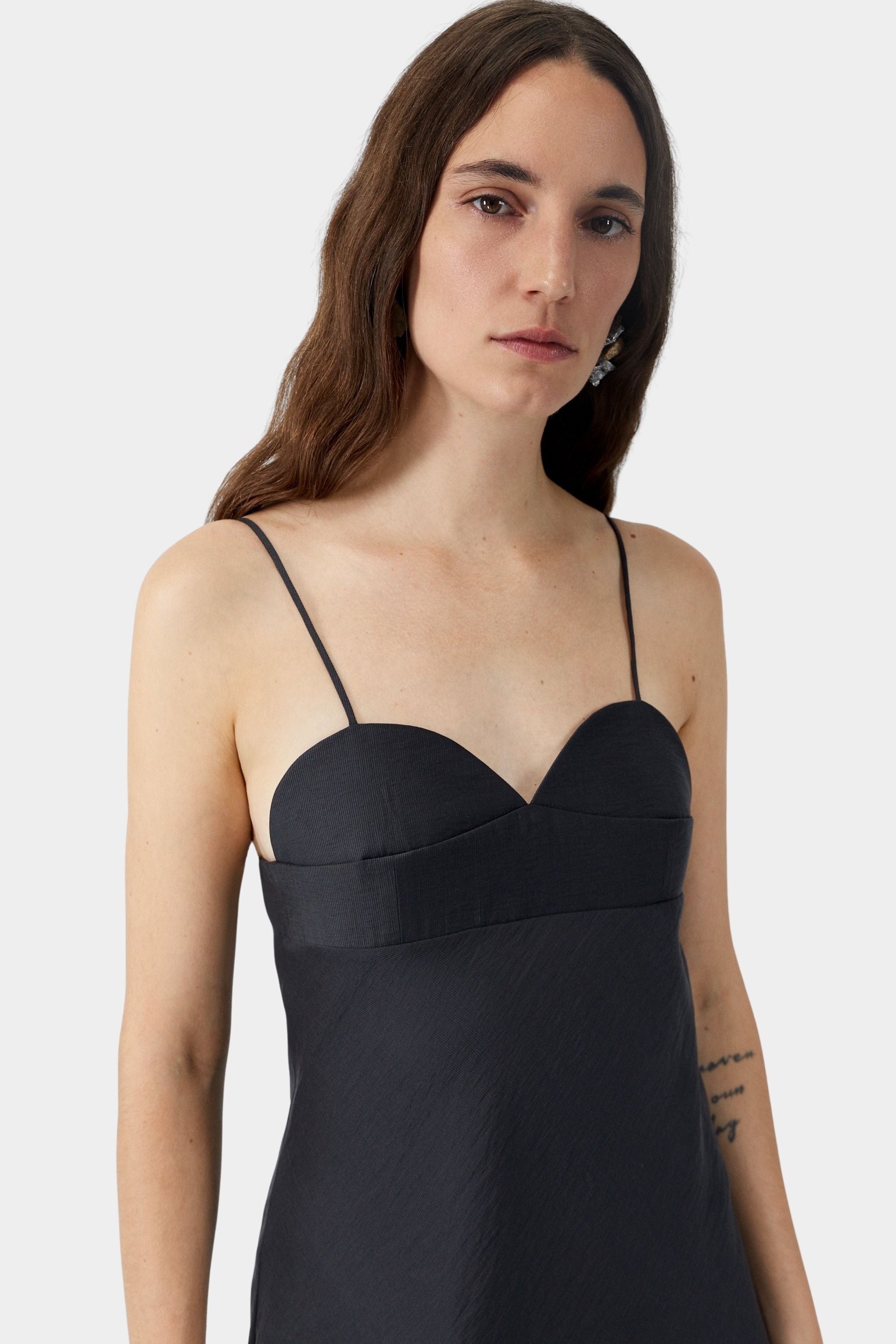 Black camisole dress with heart-shaped neckline, thin straps, and structured bust seam