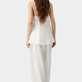 Cream camisole top with thin straps, soft back drape, and relaxed silhouette
