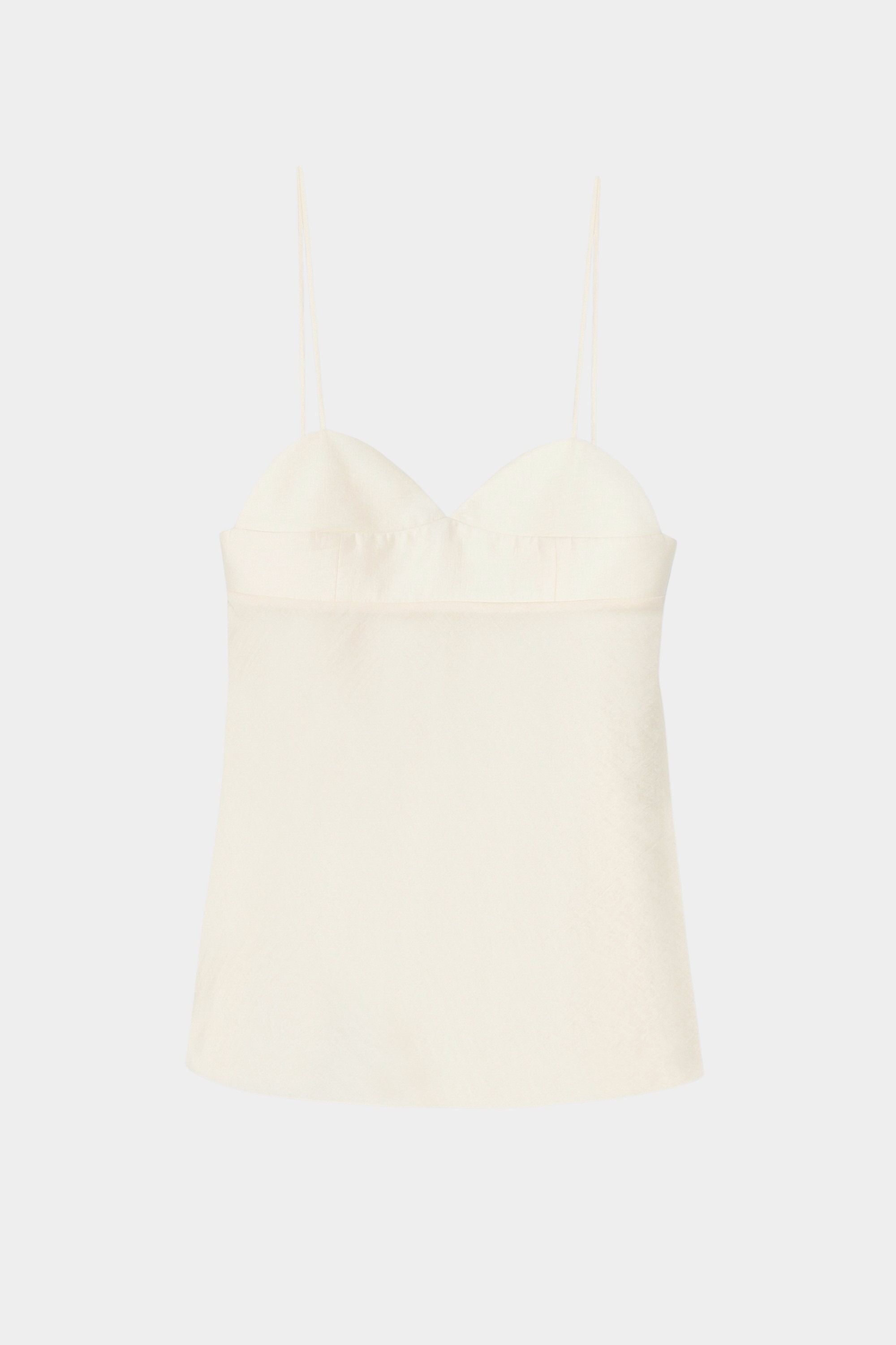 Cream heart-shaped camisole top with thin straps, structured bust, and lightly textured fabric