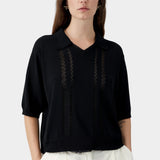 Black knit polo top with collar, V neckline, and sheer vertical lace panel detailing
