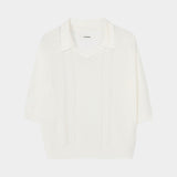 Cream short sleeve knit polo with collar, V neckline, and vertical lace panel detailing