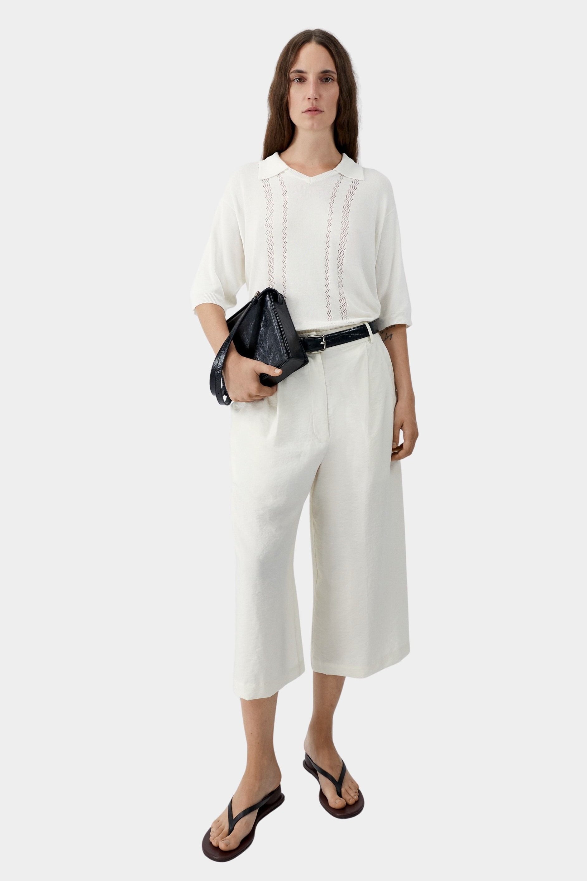 Cream lace panel polo top worn with matching wide leg cropped trousers and sandals