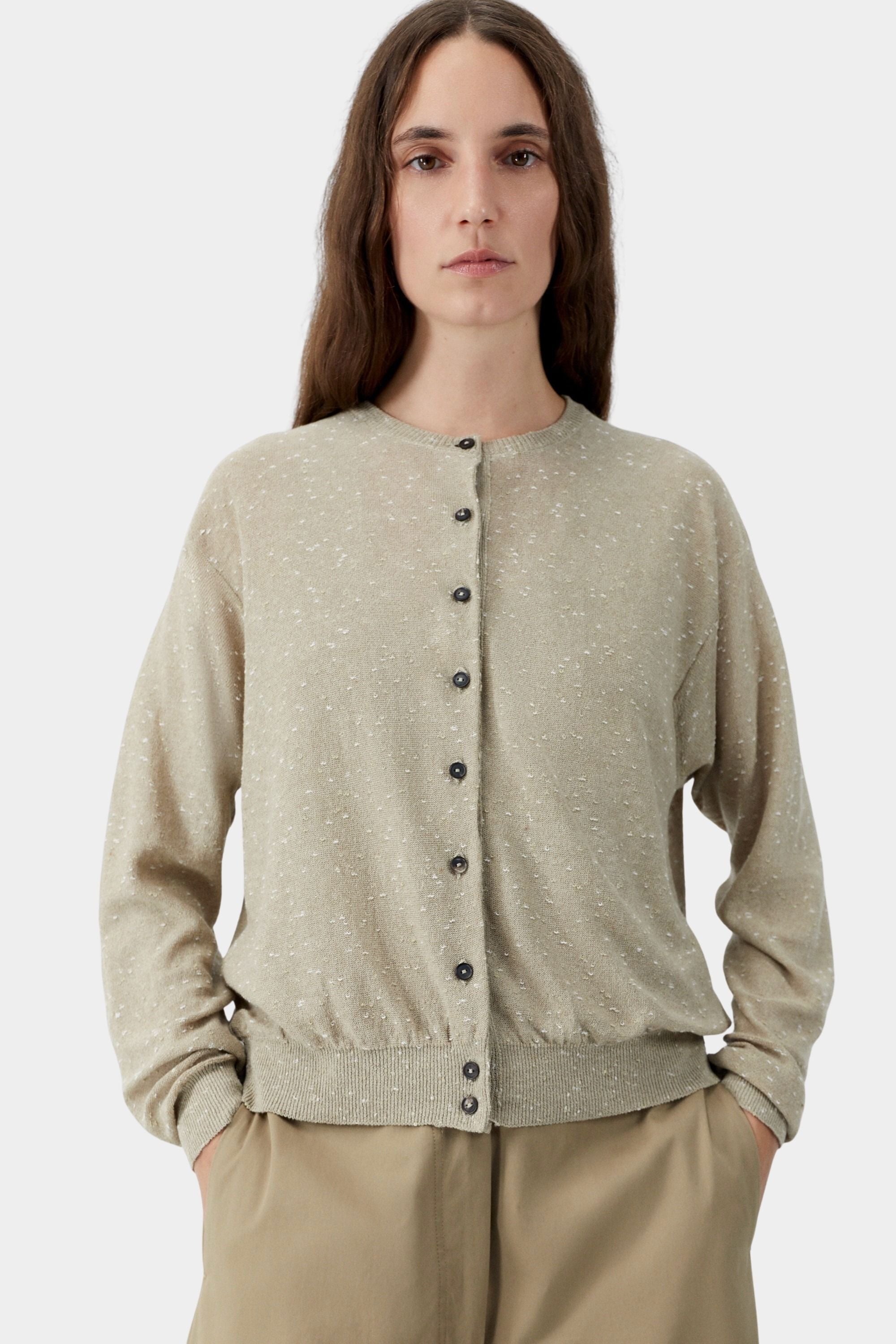 Beige flecked knit cardigan with button front closure and subtle texture