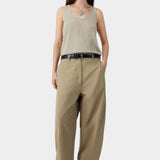 Beige flecked knit tank top worn with tailored trousers and sandals