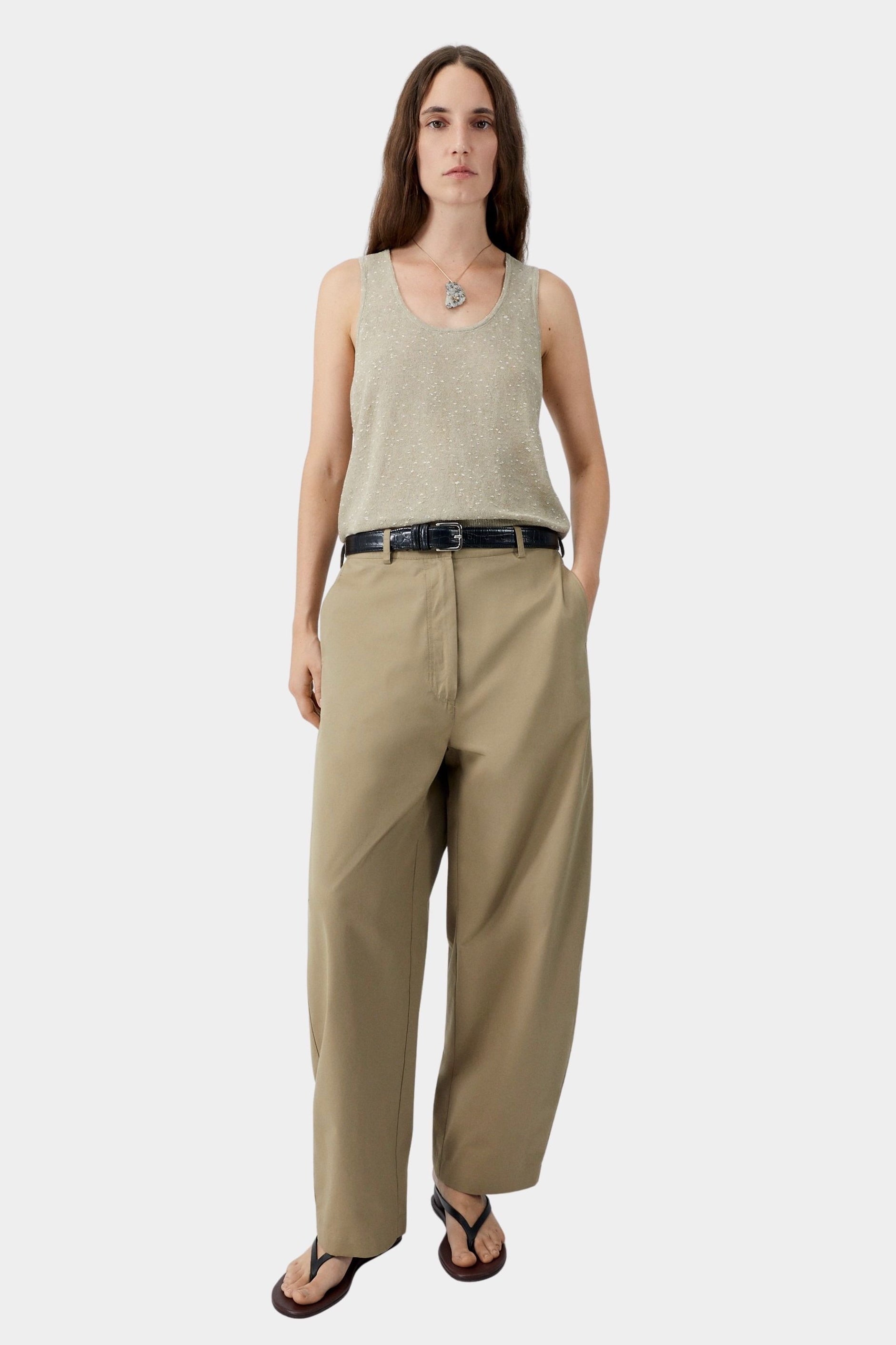 Beige flecked knit tank top worn with tailored trousers and sandals