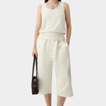 Cream flecked knit tank top worn with matching skirt and sandals